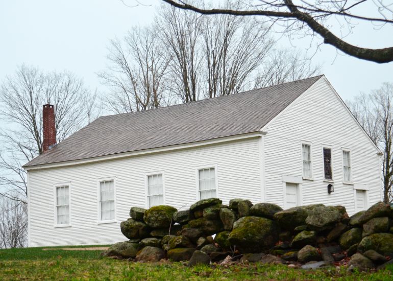 A white church with trees in the background