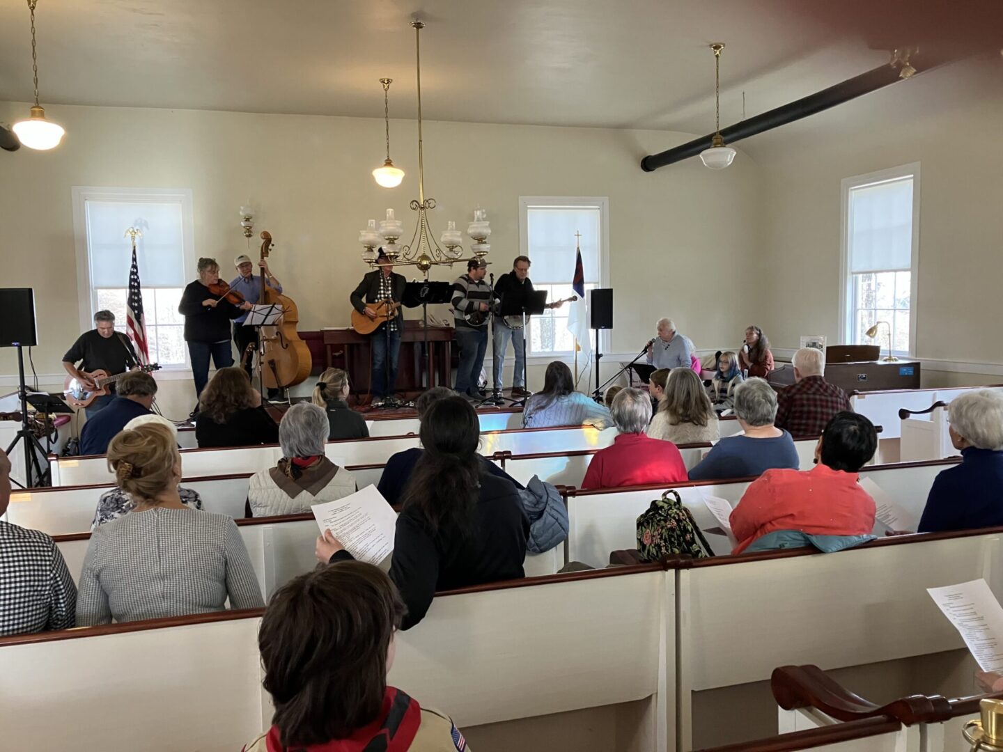 A group of people sitting in pews at a church.