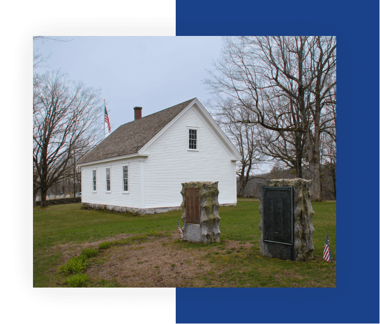 A white house sitting in the middle of a field.