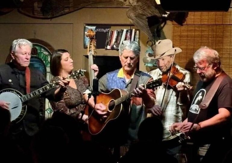 A group of people playing instruments in a room.